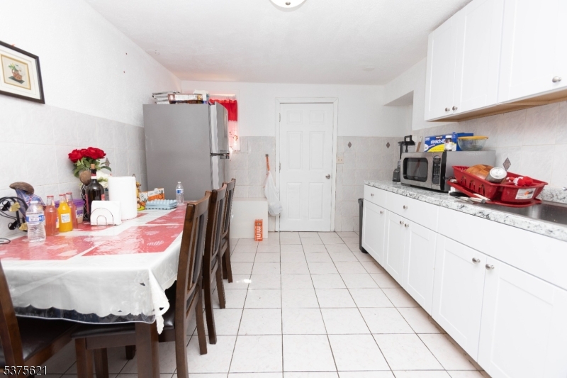 622 North 9th Street Newark, NJ 07107 - Photo 18 of 24 a kitchen with stainless steel appliances kitchen island granite countertop a refrigerator and a sink