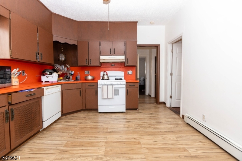 622 North 9th Street Newark, NJ 07107 - Photo 5 of 24 a kitchen with stainless steel appliances granite countertop a stove top oven and sink