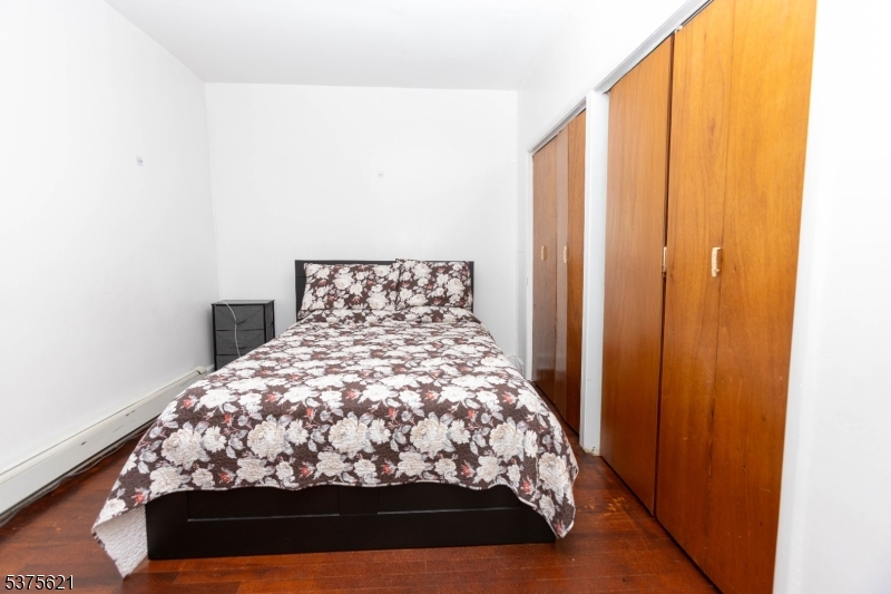 622 North 9th Street Newark, NJ 07107 - Photo 6 of 24 a bed sitting in a bedroom next to a window