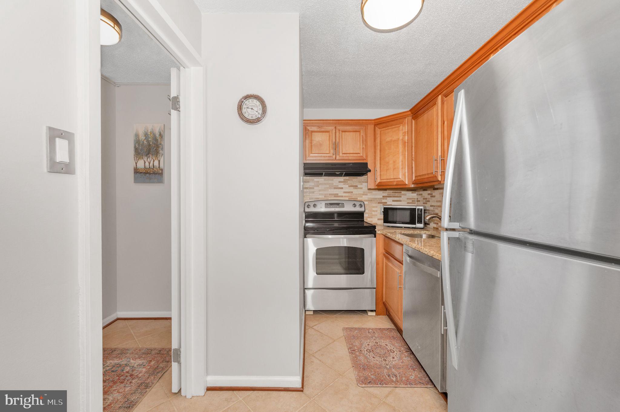 6800 Fleetwood Road, Unit 509 McLean, VA 22101 - Photo 3 of 48 a kitchen with a refrigerator a stove top oven