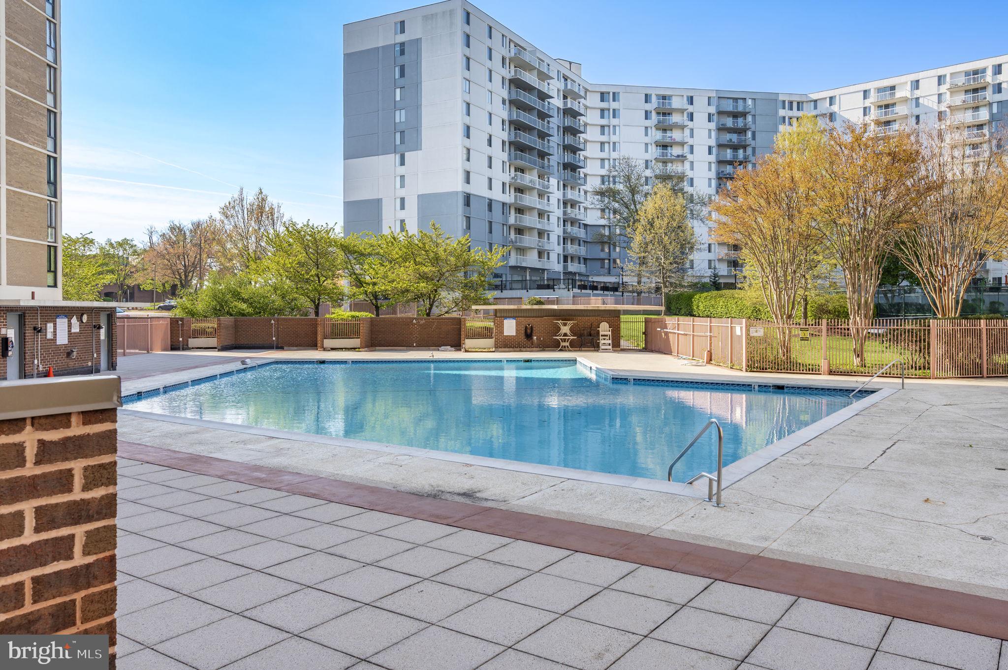 6800 Fleetwood Road, Unit 509 McLean, VA 22101 - Photo 38 of 48 a view of a swimming pool with a chair and tables in the patio