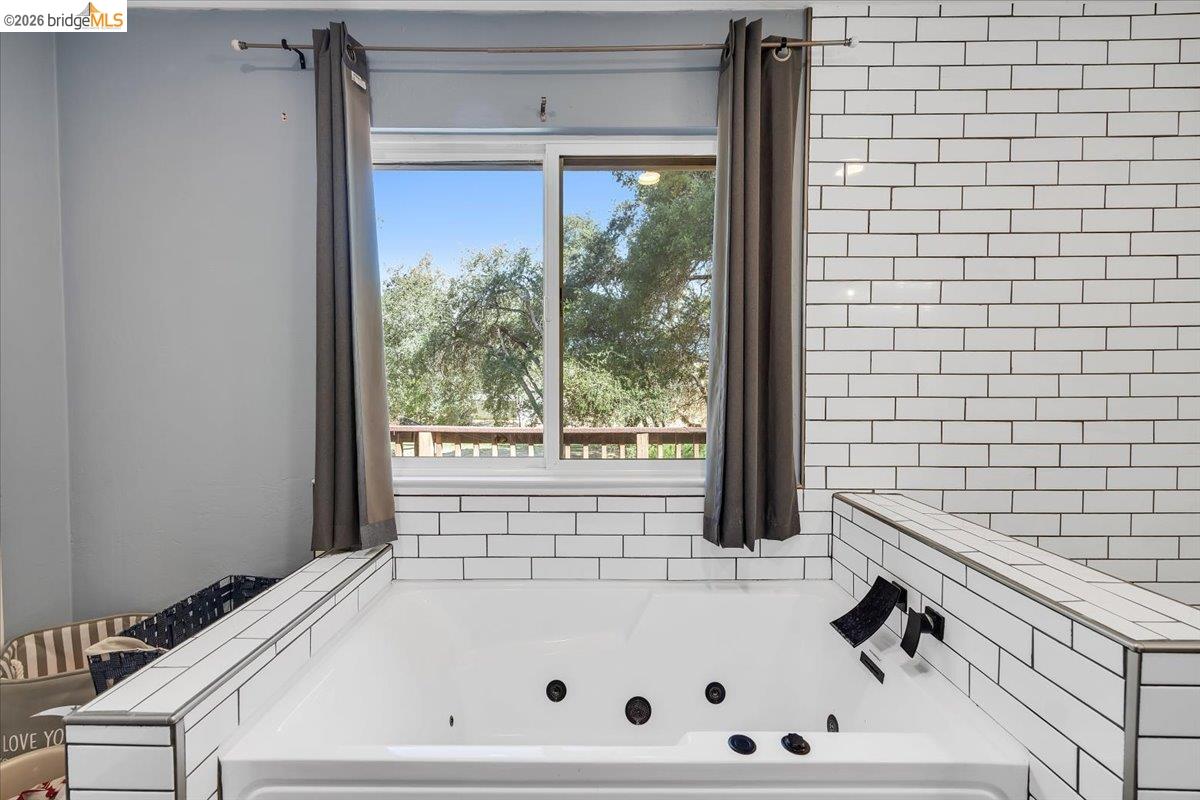 8733 Fraguero Road Sonora, CA 95370 - Photo 45 of 73 White subway tile surround framing a jetted soaking tub