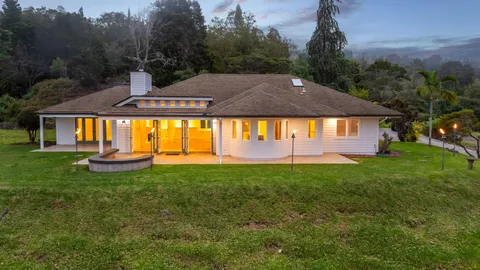 a view of a house with backyard and sitting area