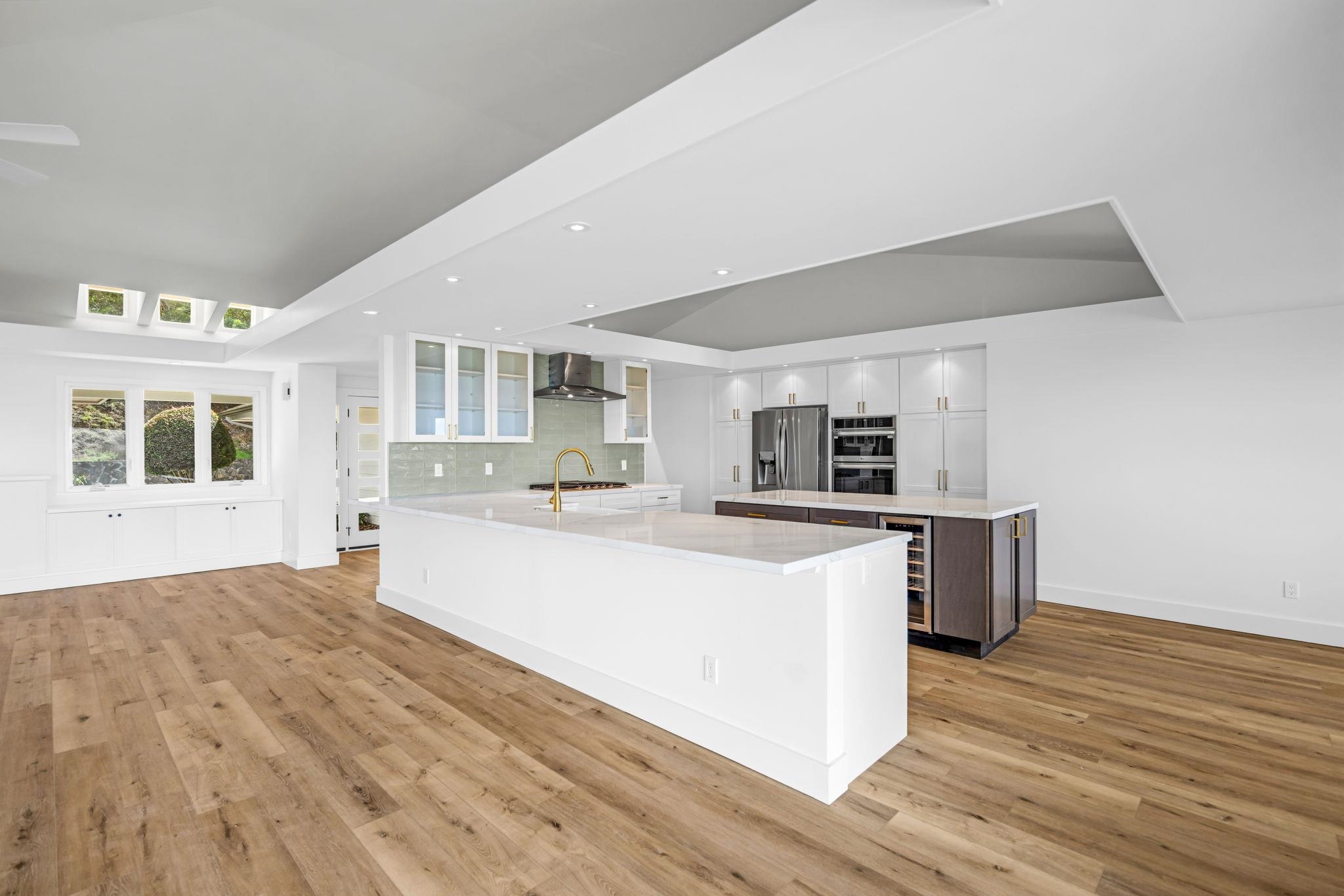7733 Kula Highway Kula, HI 96790 - Photo 15 of 43 a large white kitchen with wooden floor and a sink