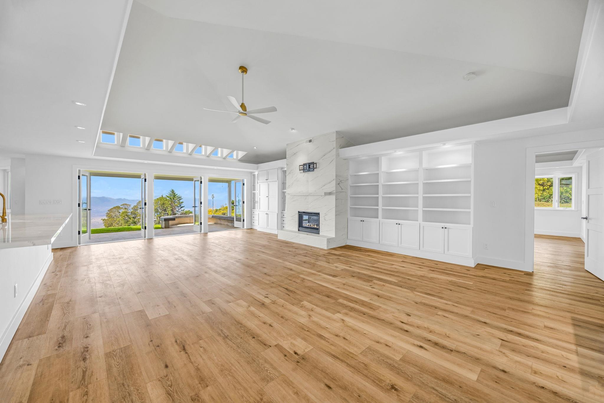 7733 Kula Highway Kula, HI 96790 - Photo 17 of 43 a view of an empty room with wooden floor and a window
