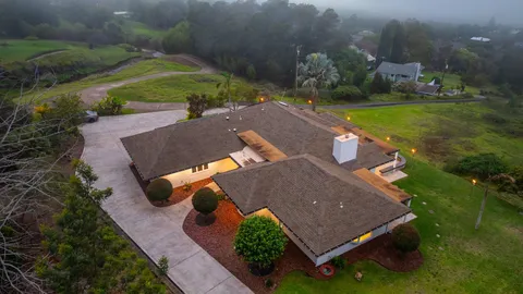 an aerial view of a house with outdoor space