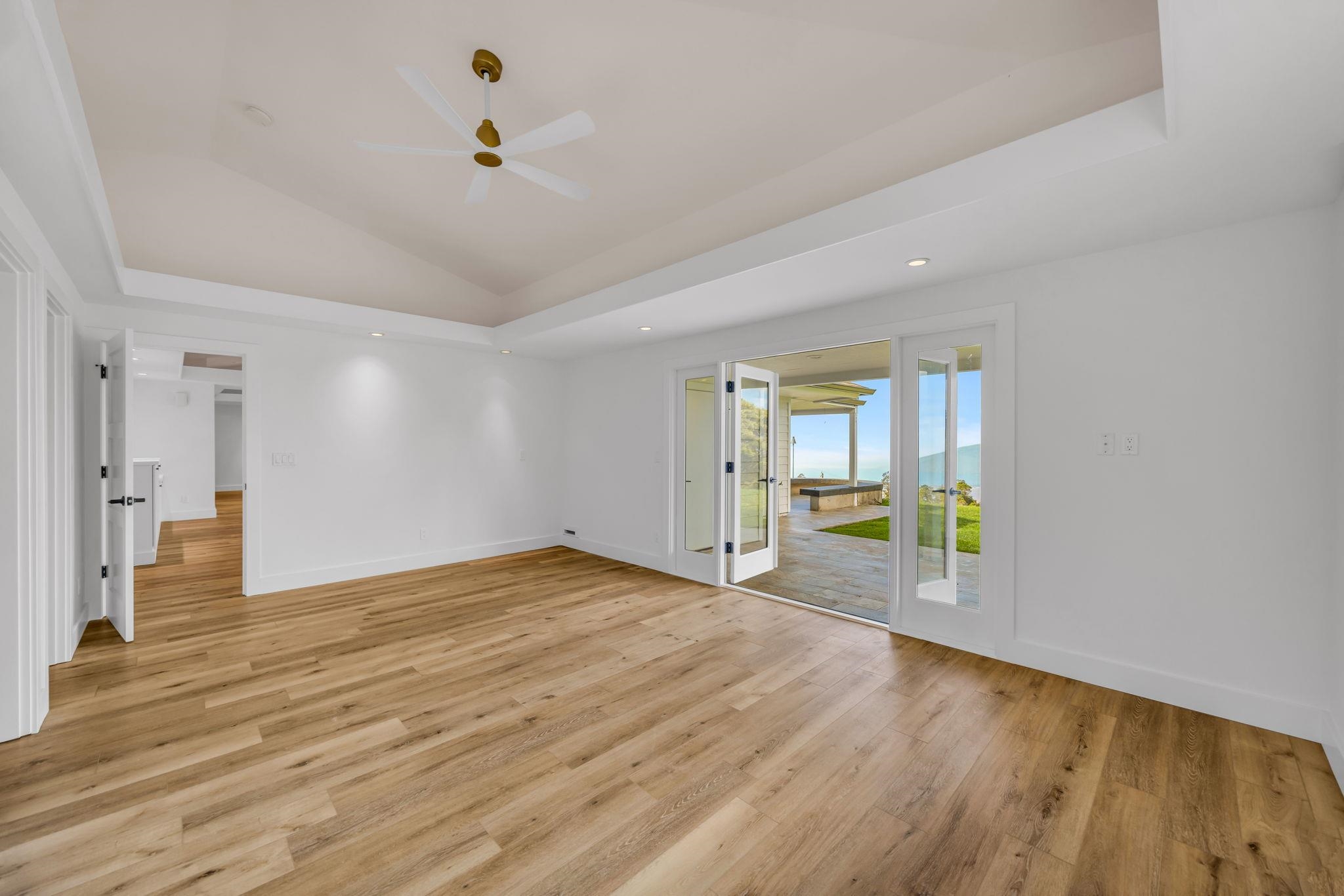 7733 Kula Highway Kula, HI 96790 - Photo 22 of 43 a view of an empty room with wooden floor and a window