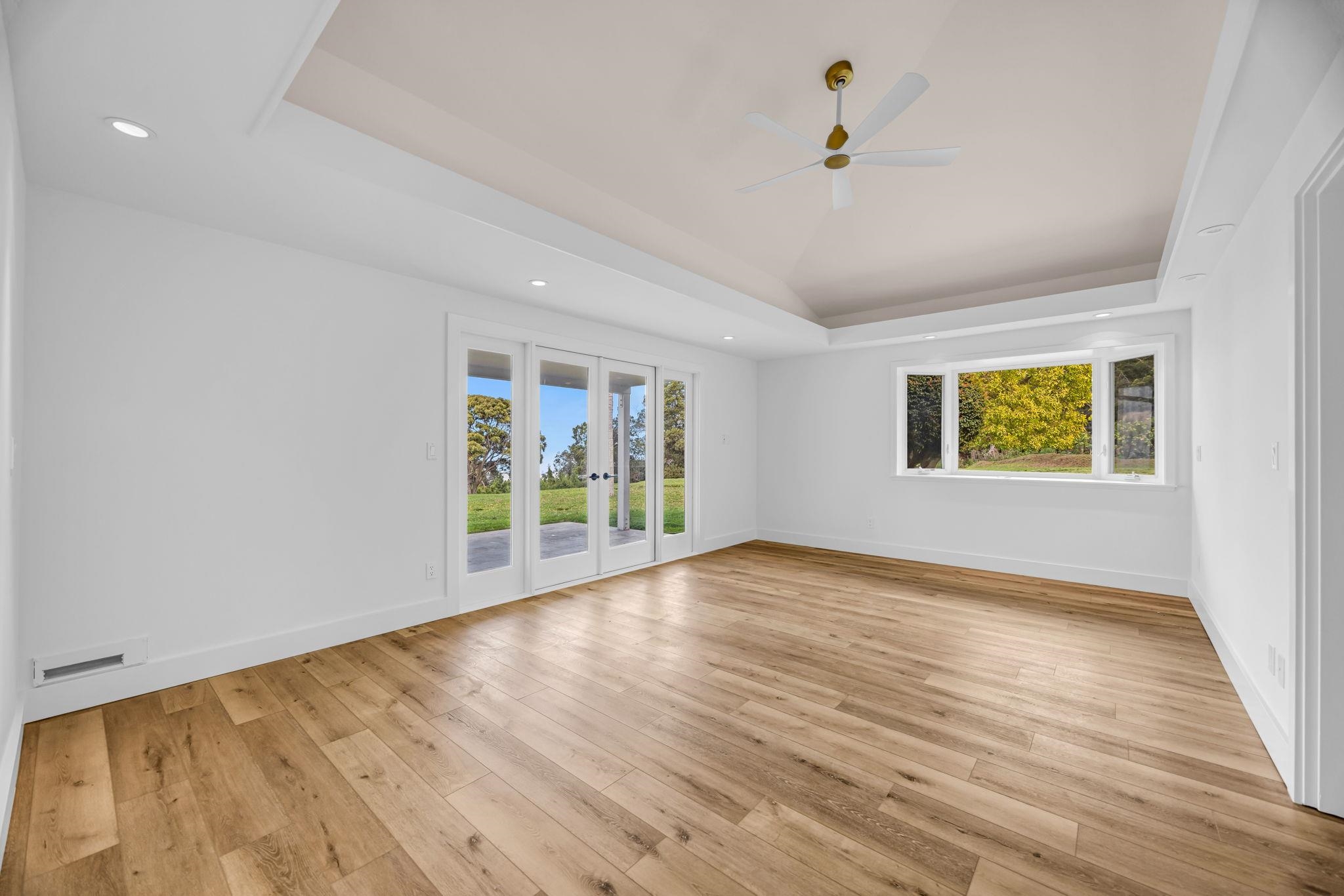 7733 Kula Highway Kula, HI 96790 - Photo 23 of 43 a view of an empty room with wooden floor and a window
