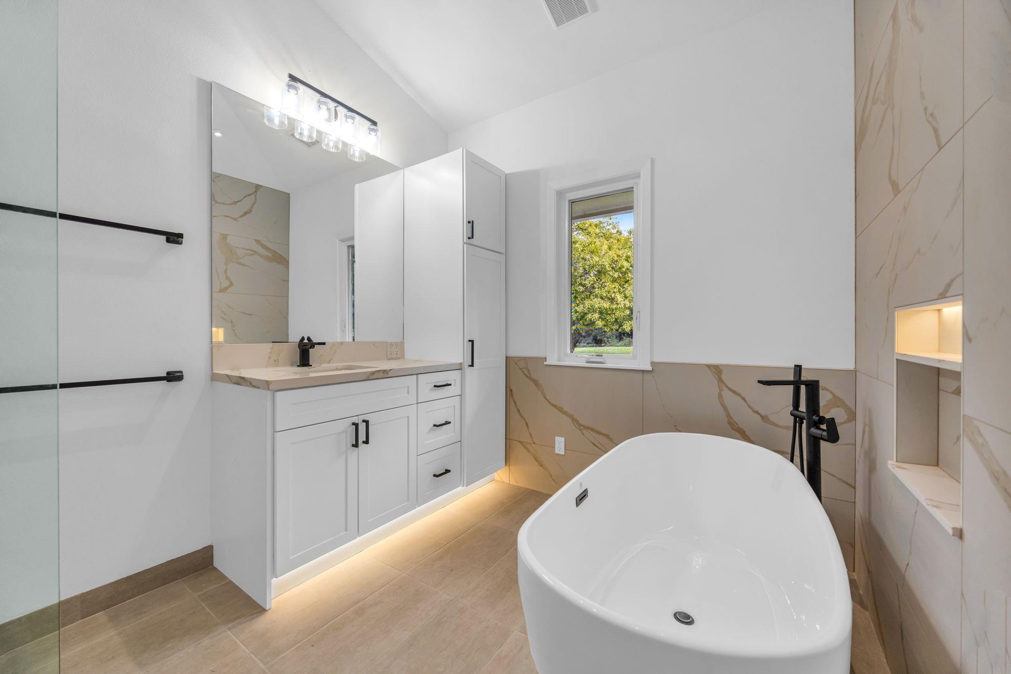 7733 Kula Highway Kula, HI 96790 - Photo 25 of 43 a en suite bathroom with a tub sink and mirror