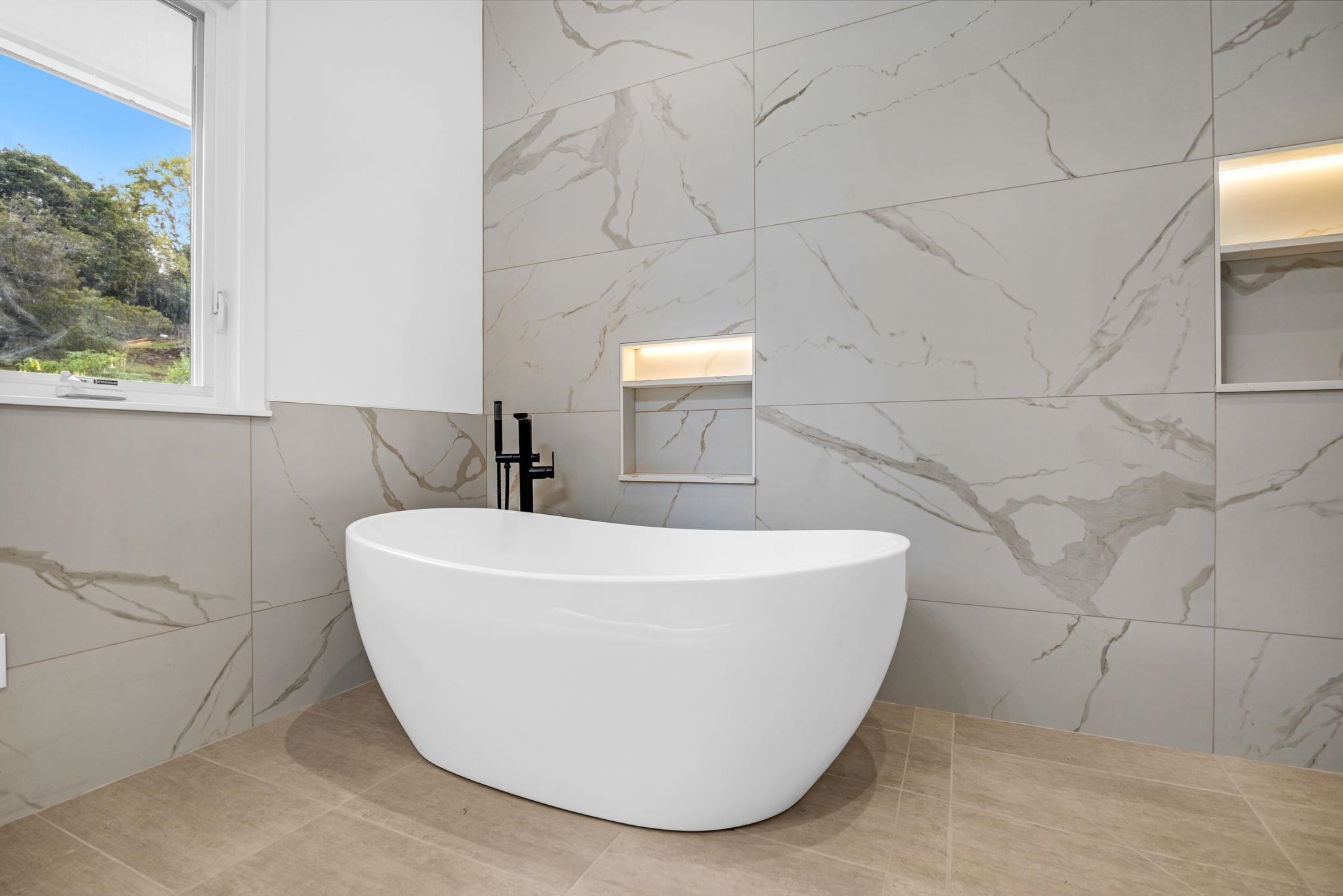 7733 Kula Highway Kula, HI 96790 - Photo 27 of 43 a white bath tub sitting in a bathroom