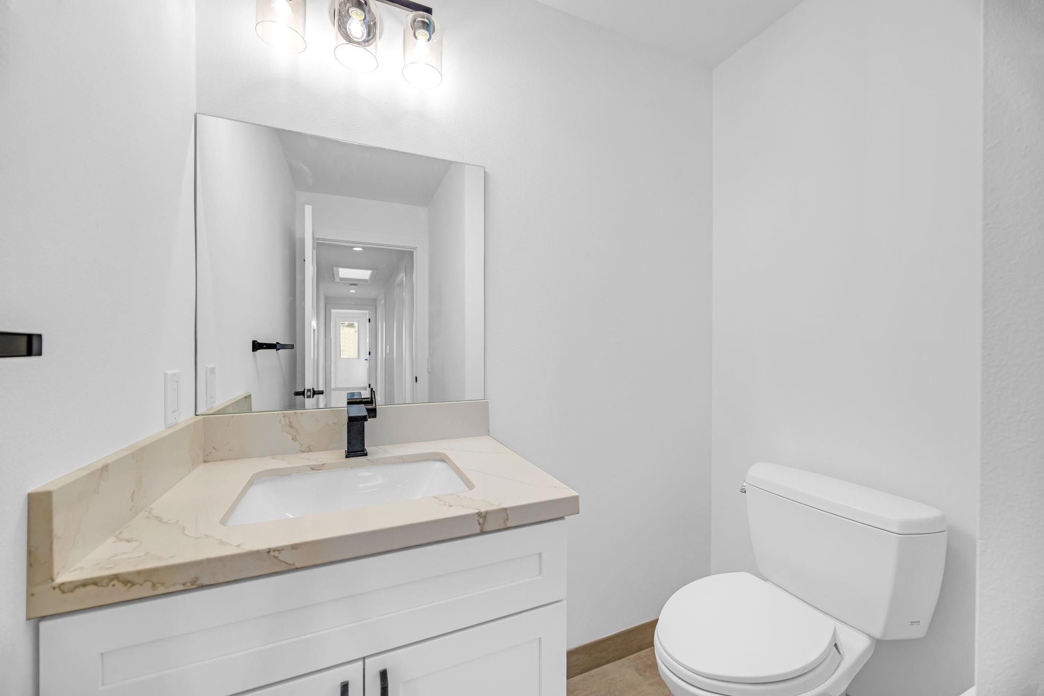 7733 Kula Highway Kula, HI 96790 - Photo 34 of 43 a bathroom with a sink toilet and mirror