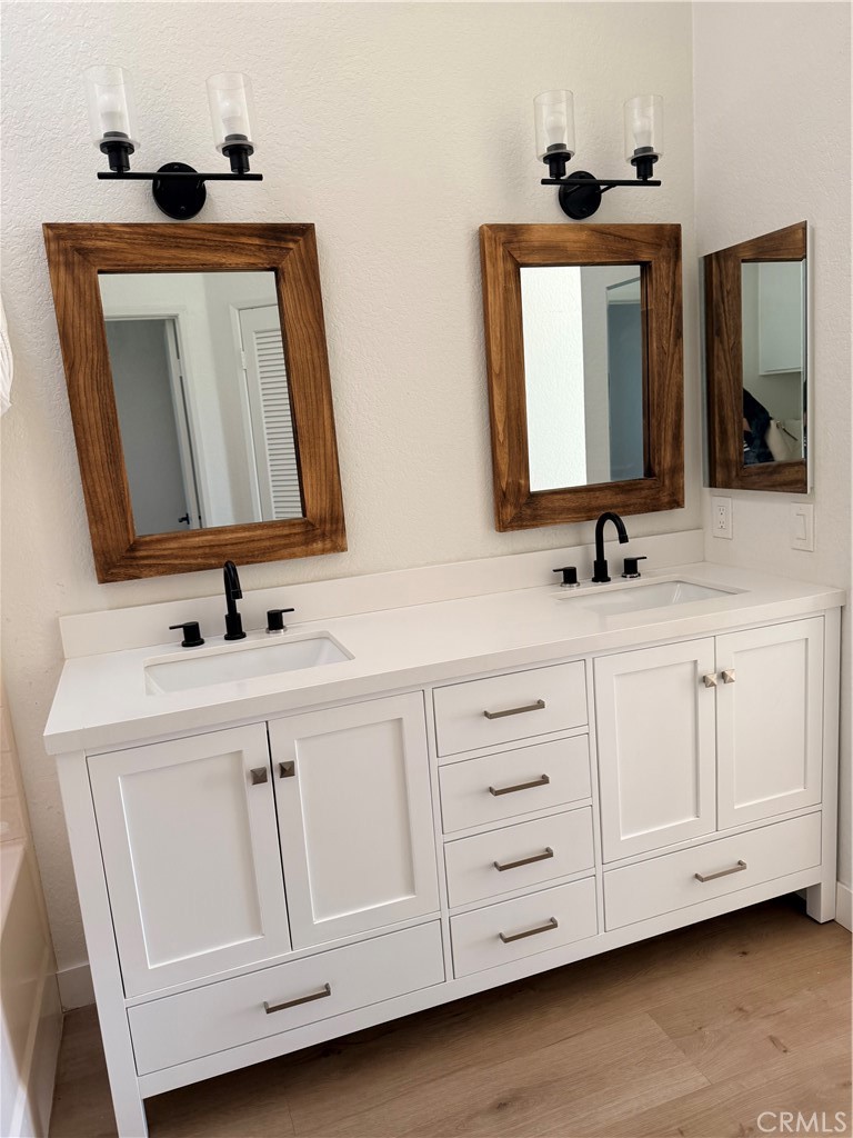 30433 Danube Court Temecula, CA 92591 - Photo 5 of 12 a bathroom with double sink and a mirror