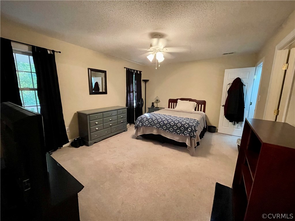 6153 Middle Road Prince George, VA 23875 - Photo 29 of 34 a bedroom with a bed a dresser next to a window