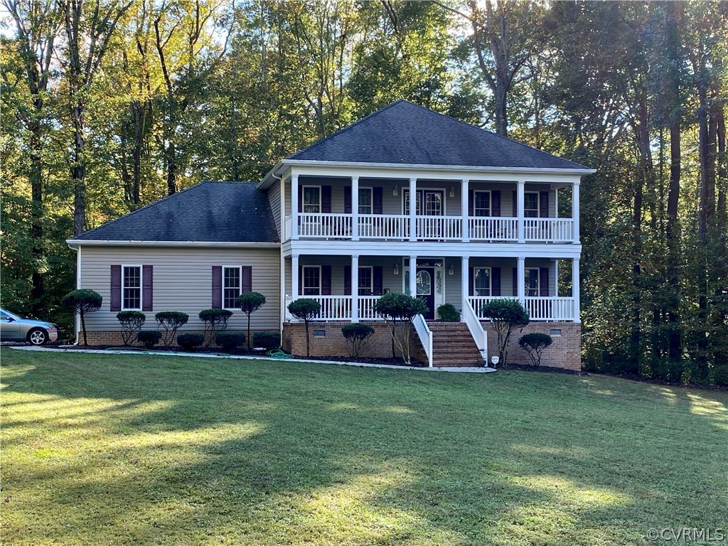 6153 Middle Road Prince George, VA 23875 - Photo 4 of 34 a front view of a house with a garden and trees