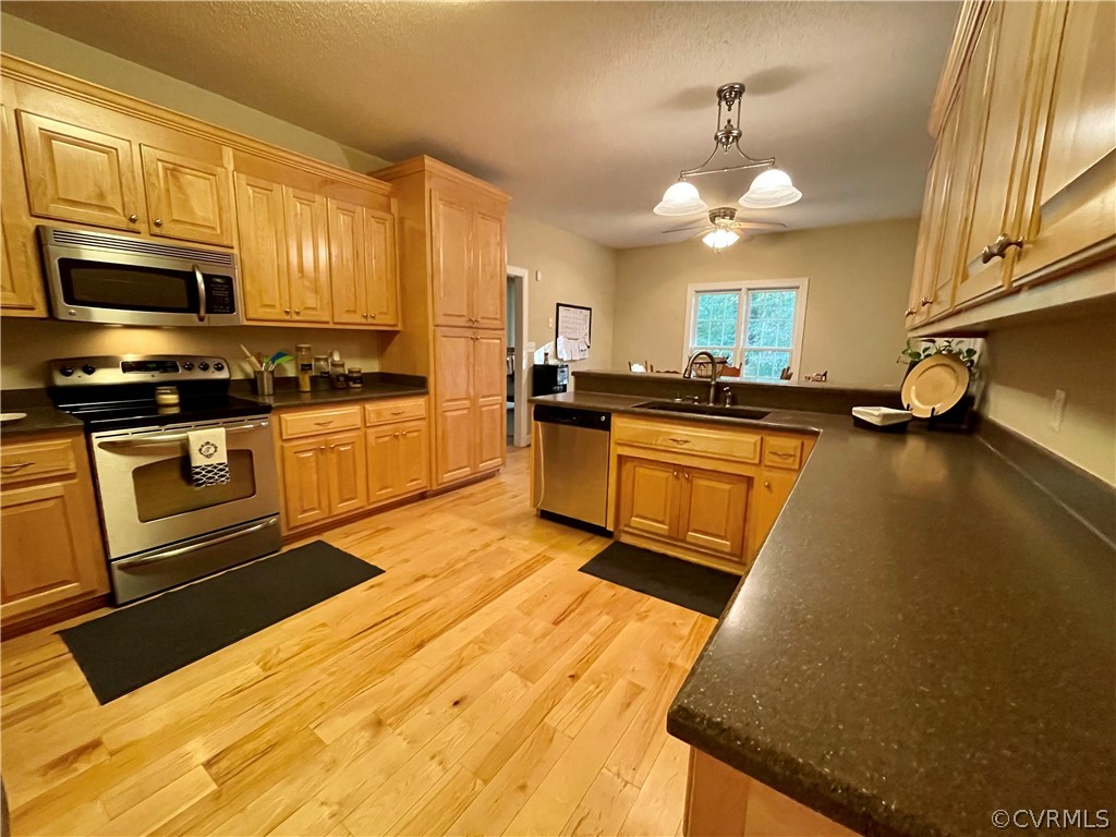 6153 Middle Road Prince George, VA 23875 - Photo 8 of 34 a kitchen with stainless steel appliances granite countertop a sink a stove top oven a chimney cabinets and a dining table