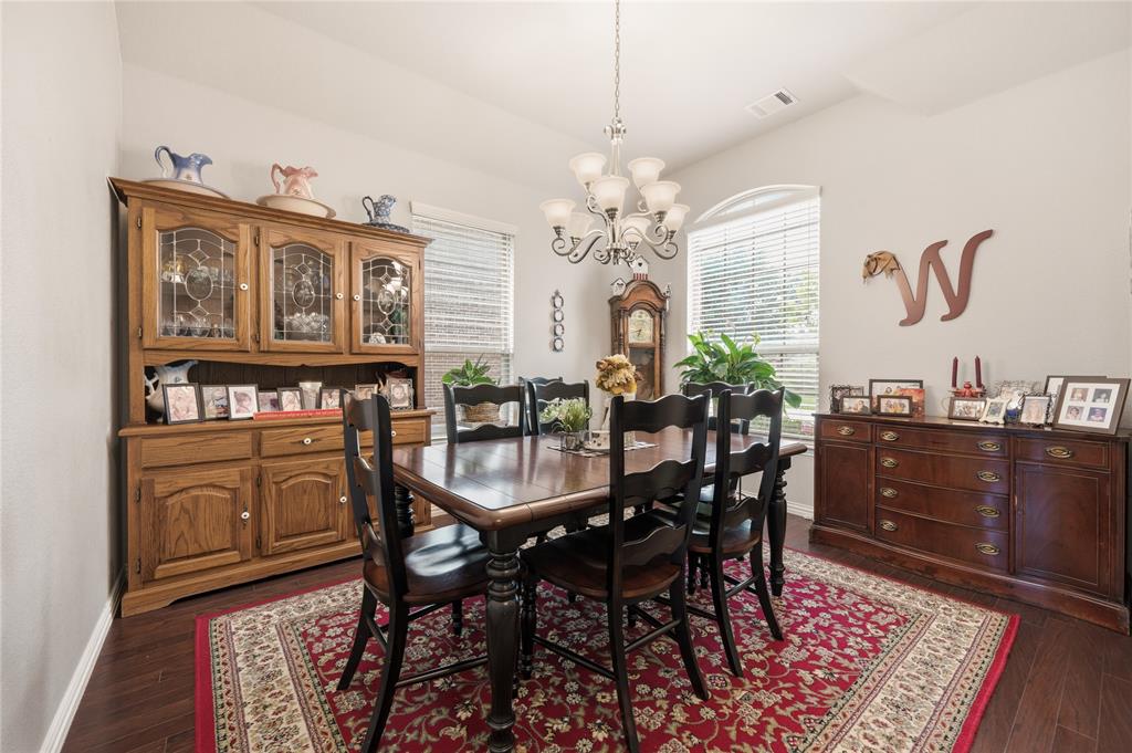 140 Chestnut Road Waxahachie, TX 75165 - Photo 6 of 26 Dining space featuring wood-finish flooring, a vaulted ceiling, and an arched window with blinds