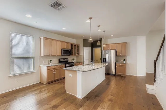 a view of kitchen with furniture and refrigerator