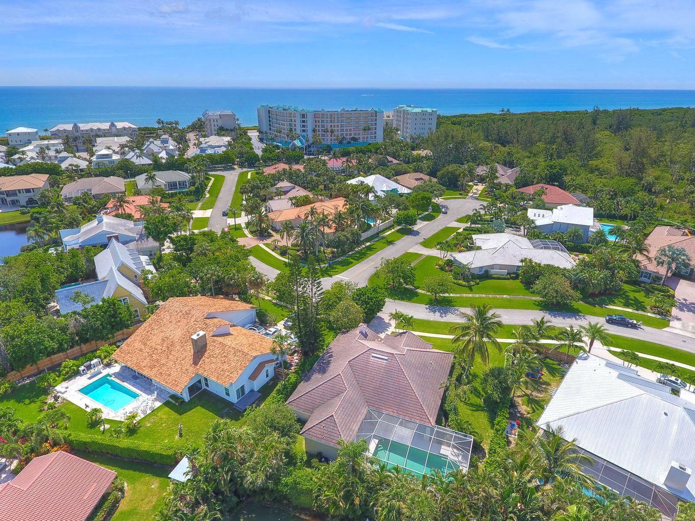 121 Olympus Way Jupiter, FL 33477 - Photo 2 of 13 an aerial view of residential houses with outdoor space and trees