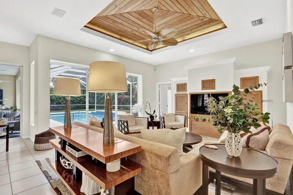 a living room with furniture a lamp and a potted plant