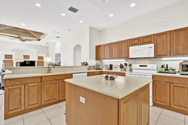 a kitchen with a sink cabinets and wooden floor