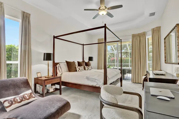 a bedroom with a bed window and couch