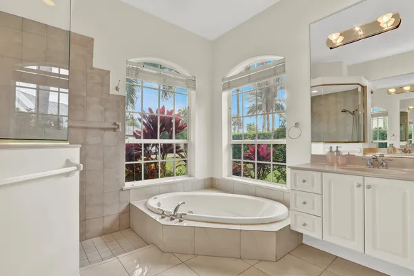 a bathroom with a bathtub sink and mirror