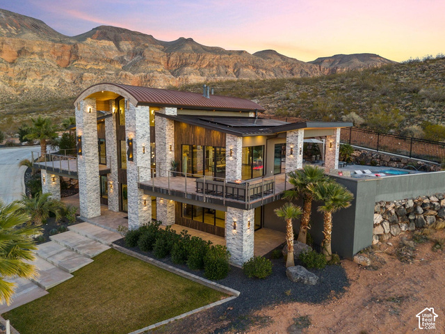 3652 South Cypress Road Hurricane, UT 84737 - Photo 2 of 81 Contemporary exterior with stacked stone accents, multiple balconies, a flat roofline, and an integrated swimming pool