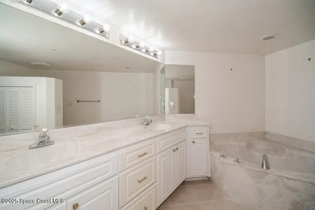 a spacious bathroom with a granite countertop sink a mirror and a