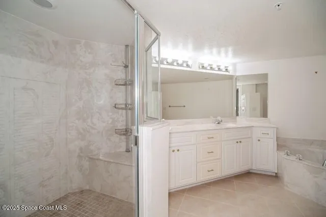 a bathroom with a double vanity sink mirror and shower