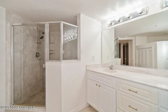 a bathroom with a shower sink and mirror