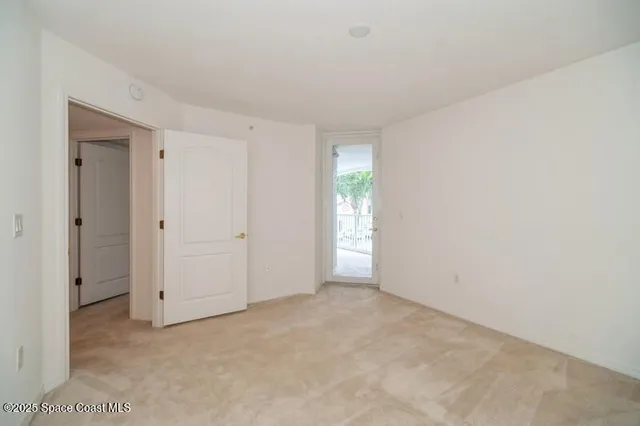 a view of an empty room and closet area