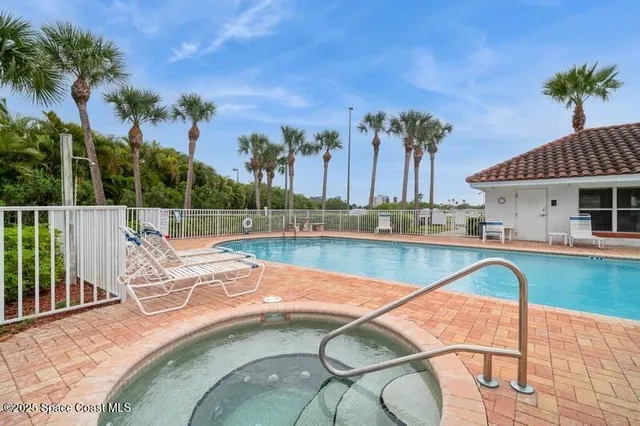 swimming pool view with a seating space