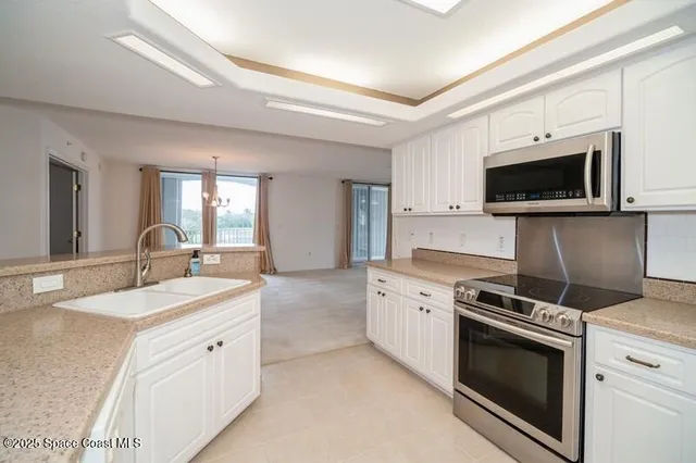 a kitchen with a sink stove and microwave