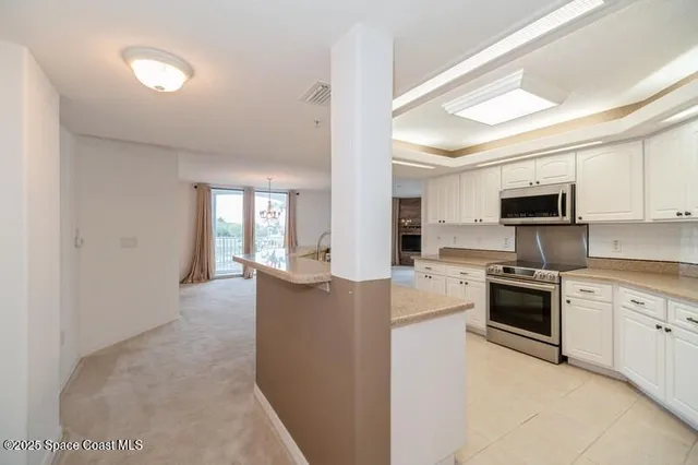 a view of a kitchen with microwave and cabinets