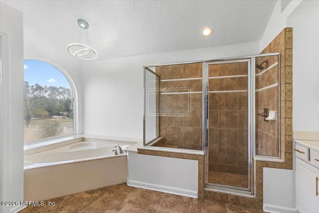 a bathroom with a tub and a shower