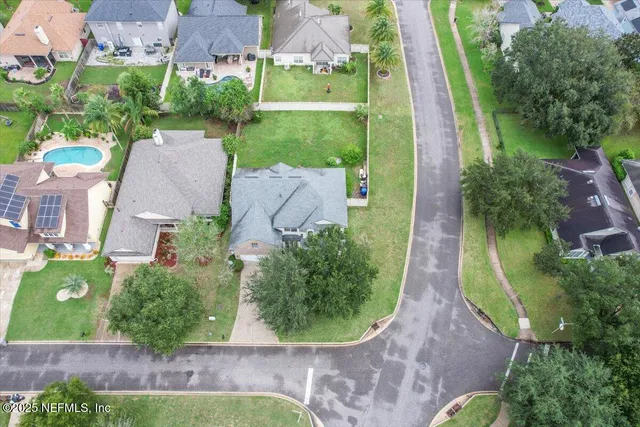 an aerial view of a house with outdoor space and tennis court