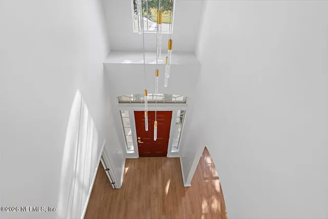 a view of a livingroom with wooden floor and a window