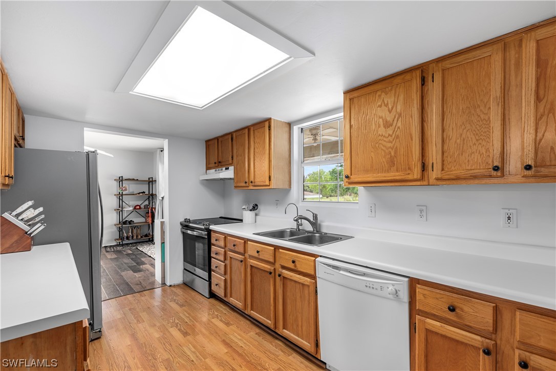 22561 Tuckahoe Road Alva, FL 33920 - Photo 12 of 32 a kitchen with stainless steel appliances granite countertop a sink stove and cabinets