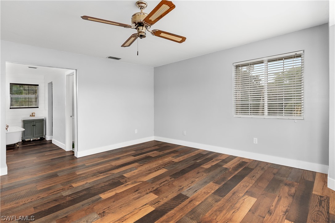 22561 Tuckahoe Road Alva, FL 33920 - Photo 25 of 32 a view of an empty room with wooden floor and a window