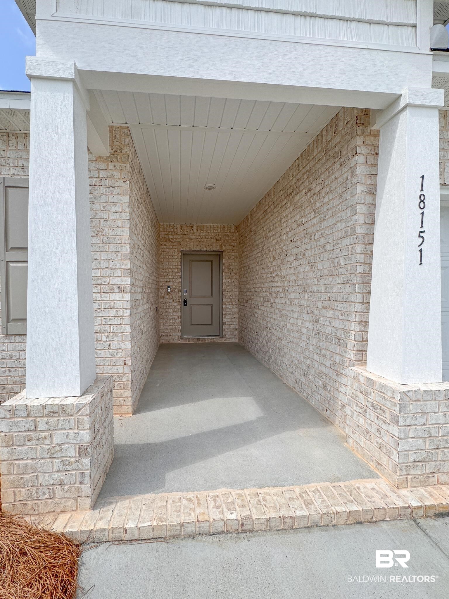18151 Kent Circle Foley, AL 36535 - Photo 3 of 25 Covered front entrance featuring light-toned brickwork and white columns