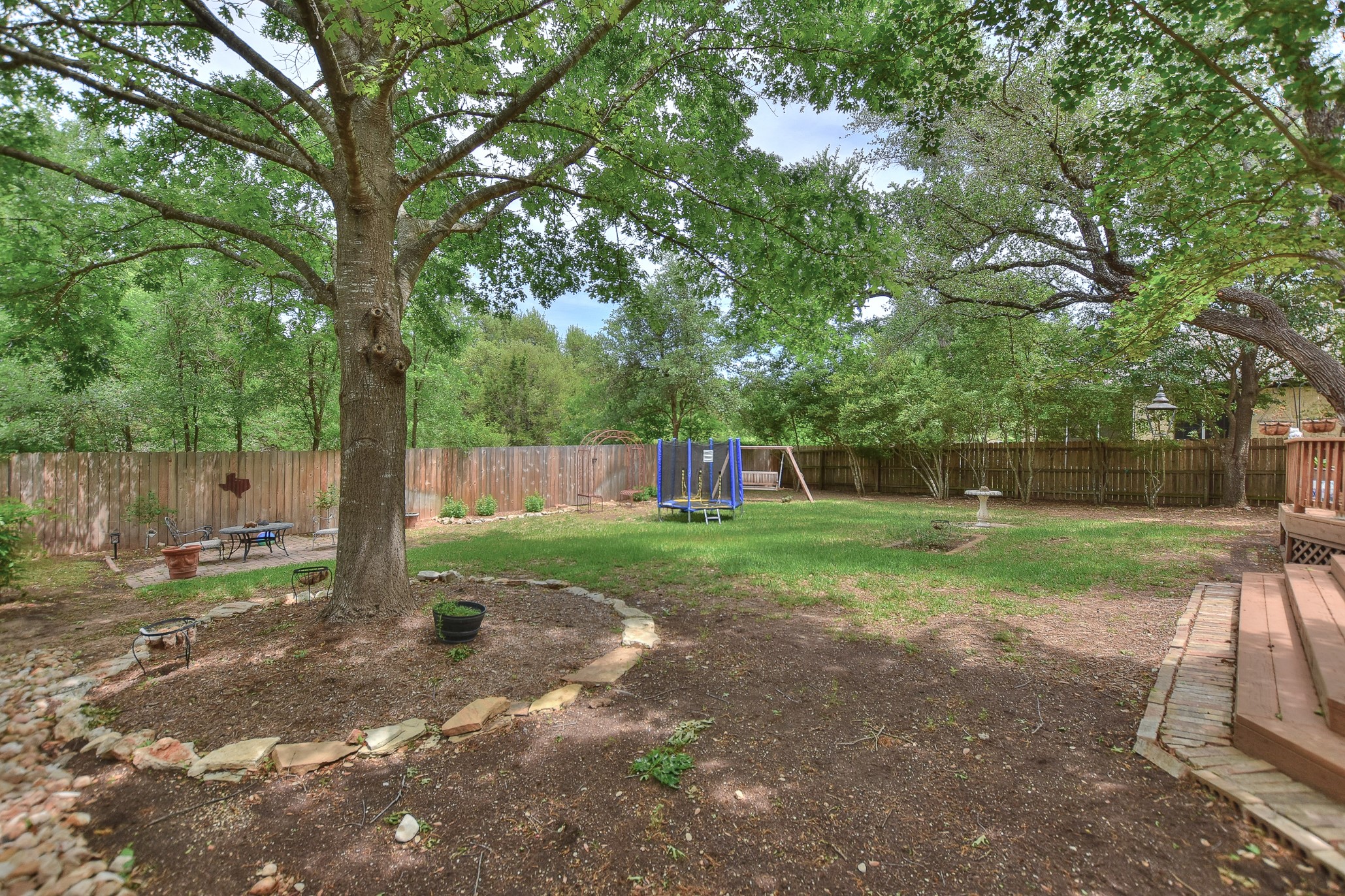 1609 Colton Way Cedar Park, TX 78613 - Photo 20 of 24 A spacious, naturally illuminated yard offers ample room for recreation and peaceful enjoyment, framed by mature trees and a sturdy fence.