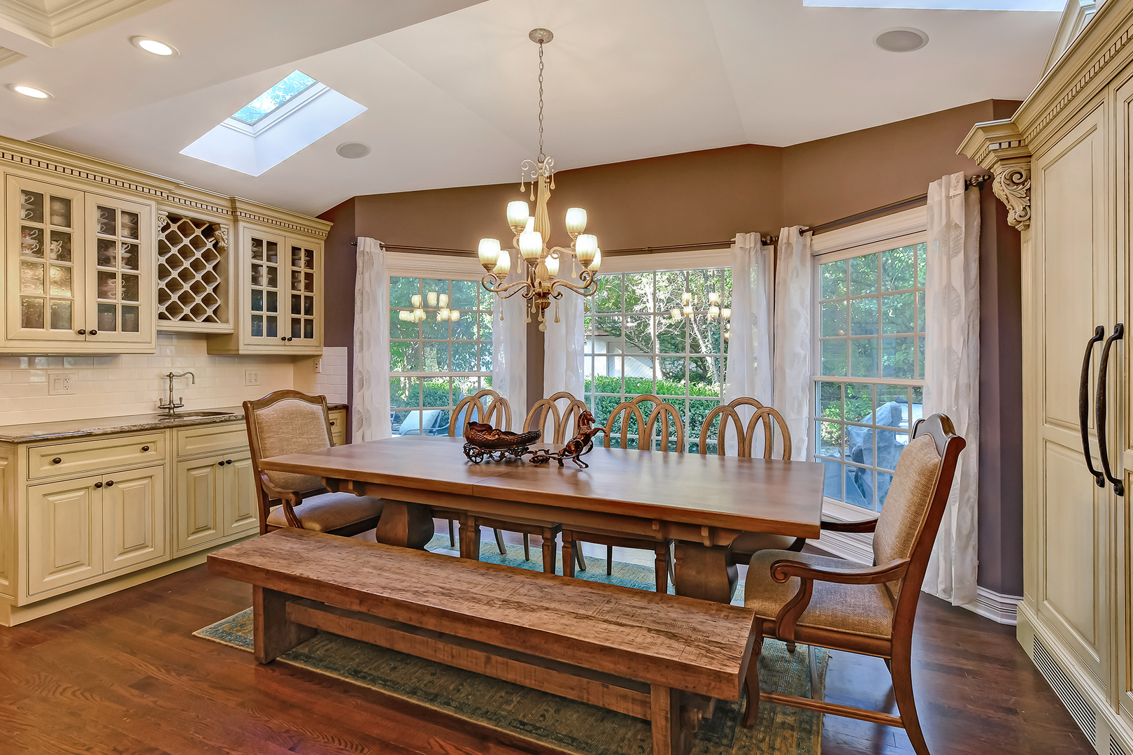 6116 South County Line Road Burr Ridge, IL 60527 - Photo 17 of 66 a dining room with furniture a chandelier and wooden floor