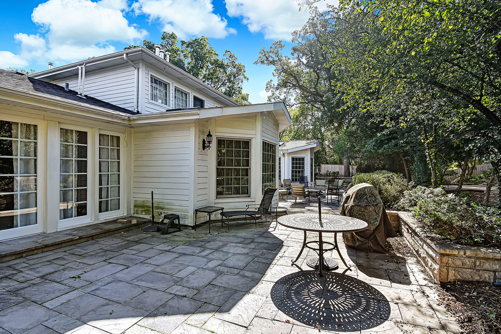 6116 South County Line Road Burr Ridge, IL 60527 - Photo 50 of 66 a patio with a table and chairs and potted plants