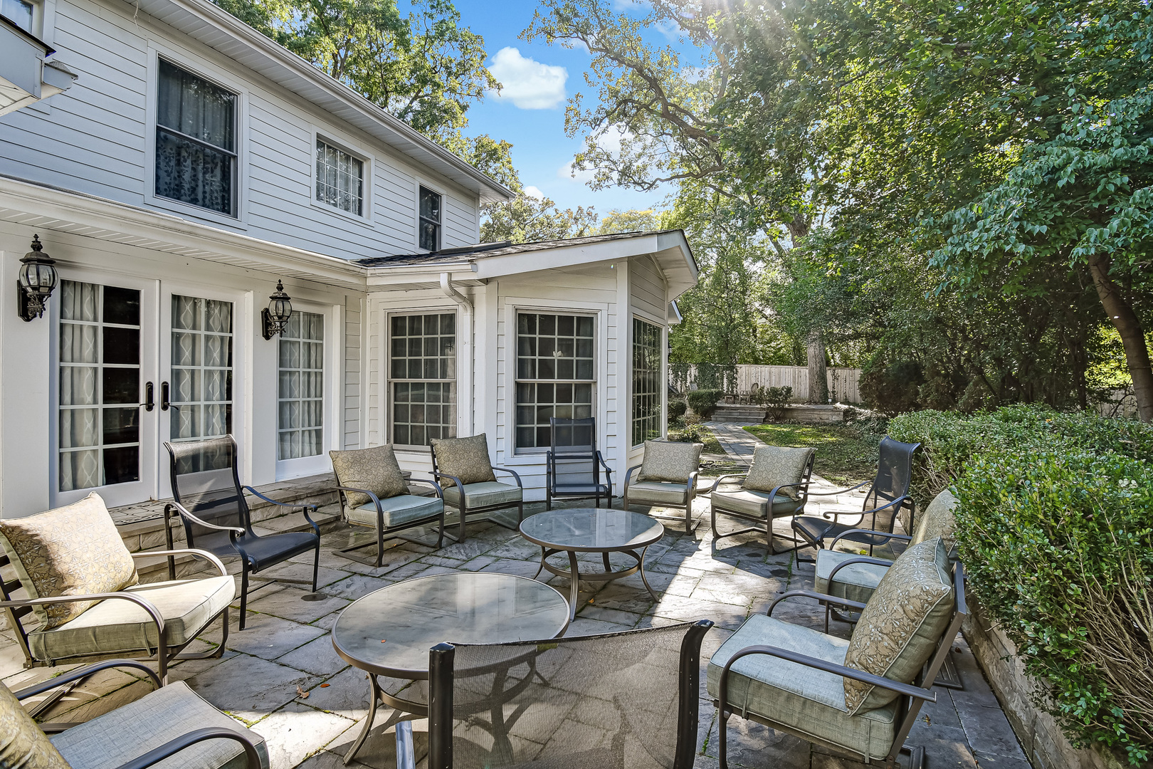 6116 South County Line Road Burr Ridge, IL 60527 - Photo 51 of 66 a view of a patio with couches table and chairs and potted plants