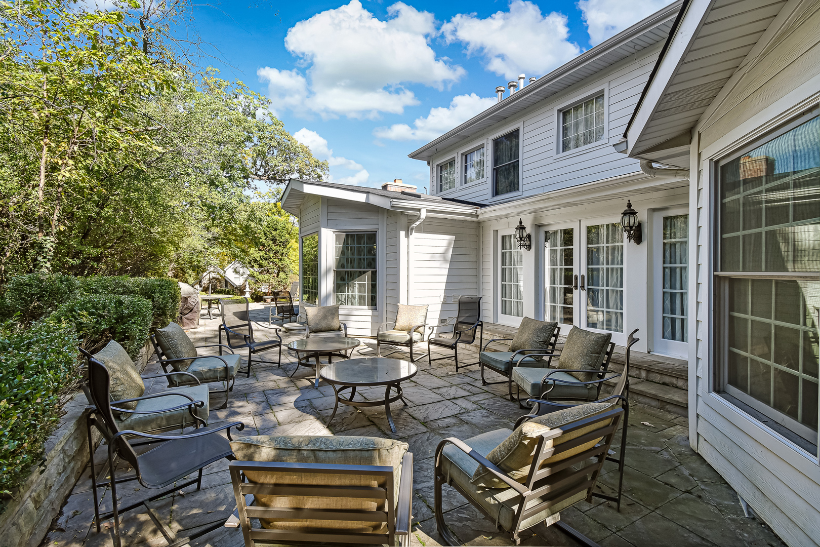 6116 South County Line Road Burr Ridge, IL 60527 - Photo 52 of 66 a view of a patio with couches table and chairs and potted plants