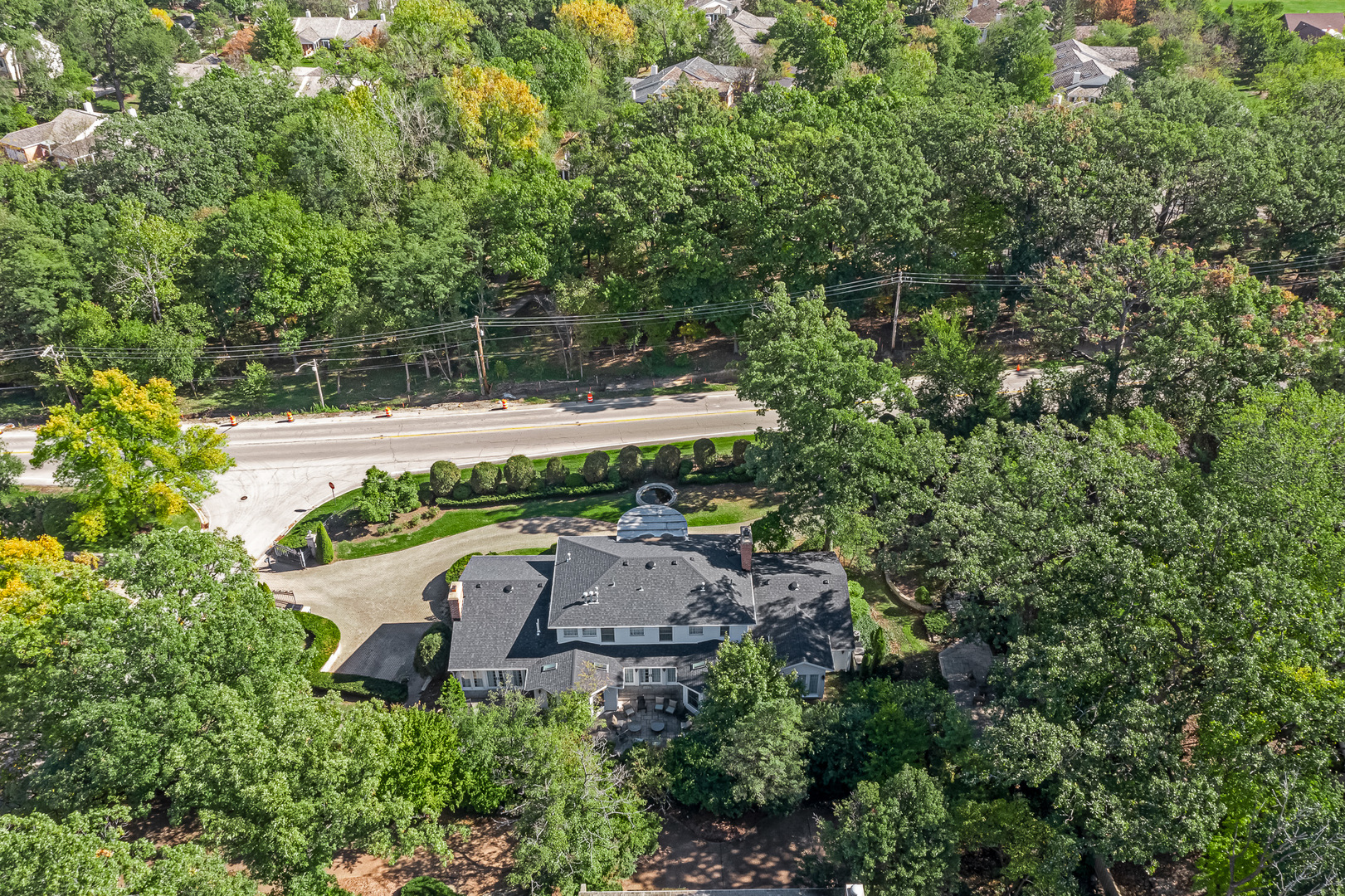 6116 South County Line Road Burr Ridge, IL 60527 - Photo 61 of 66 a view of a house with a small yard and large trees