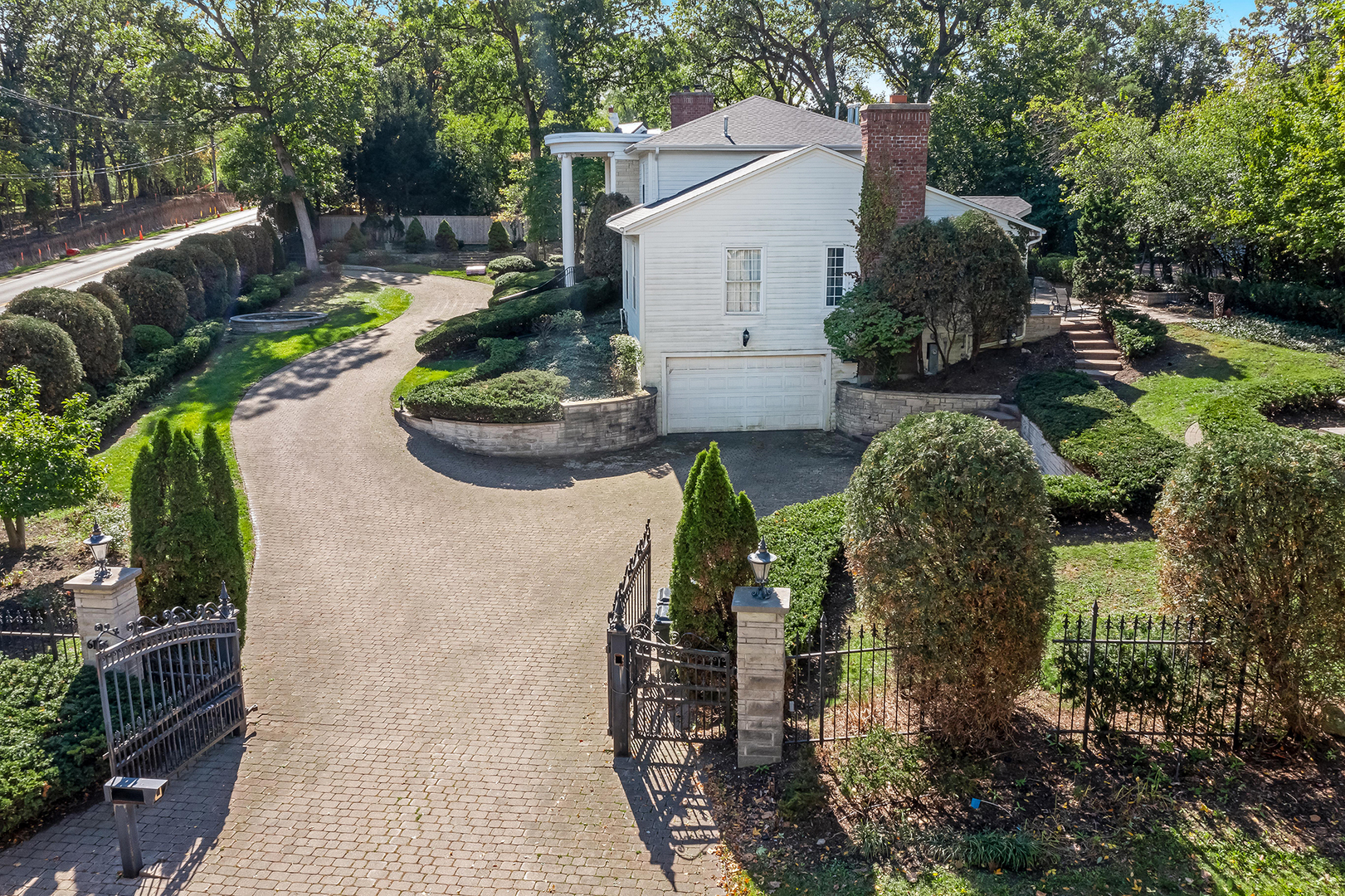 6116 South County Line Road Burr Ridge, IL 60527 - Photo 63 of 66 a view of a patio with table and chairs potted plants