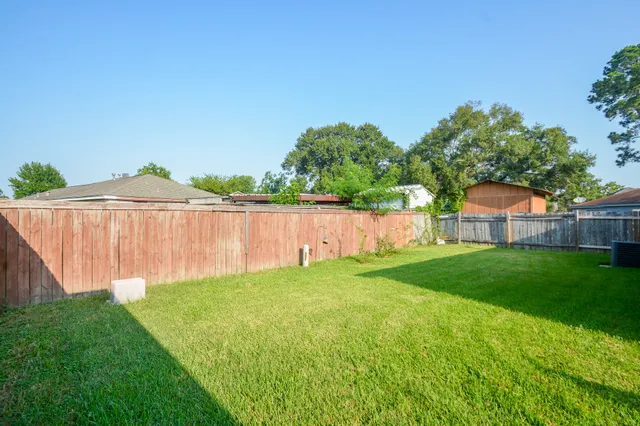 a view of backyard of house with seating space
