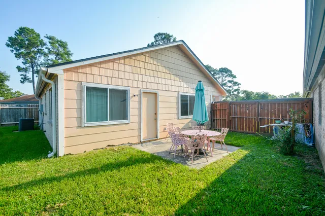 a view of a house with backyard and sitting area