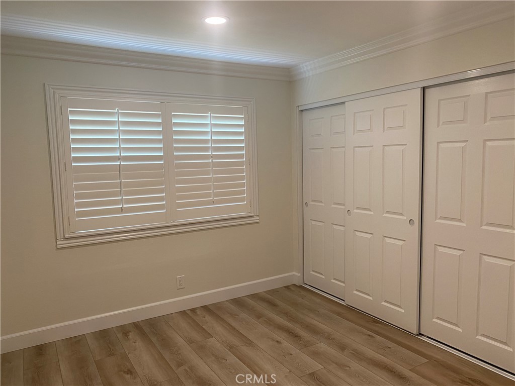 430 Buttonwood Drive Brea, CA 92821 - Photo 12 of 27 a view of an empty room with wooden floor and a window